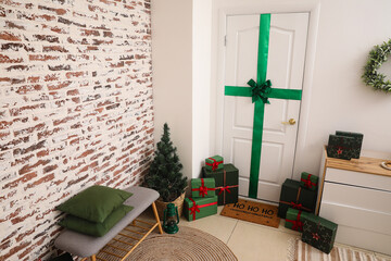 Interior of hall with white door, Christmas presents and bench