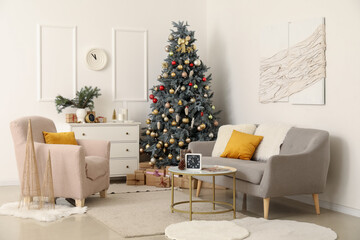 Interior of living room with clocks, sofa and Christmas tree