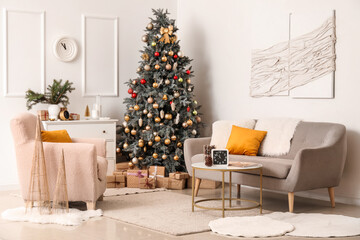 Interior of living room with clocks, sofa and Christmas tree