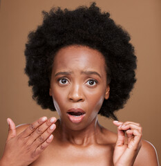 Hair, portrait and black woman in studio for problem, hair loss and hair care against a brown...