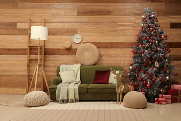 Interior of living room with sofa, wooden reindeer and Christmas tree