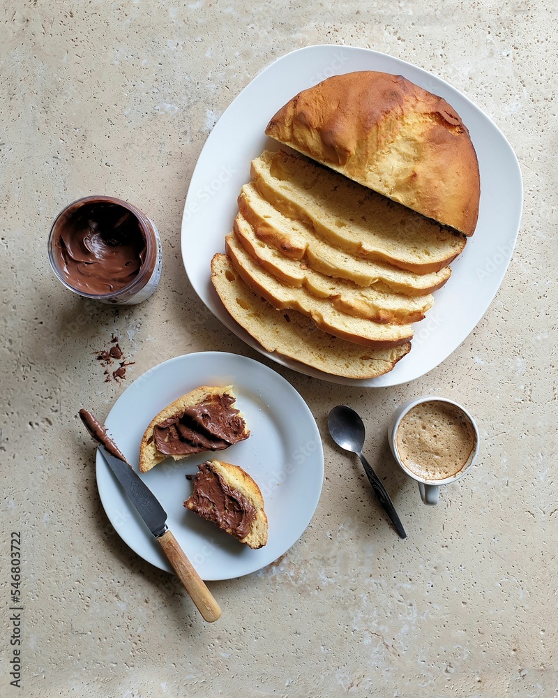 Wall mural Vertical top view of a table with bread and chocolate and a cup of coffee