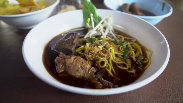 Braised chicken wings chicken feet chicken blood bitter gourd noodle.food lunch.Bitter Gourd Chicken Noodle with Herb.