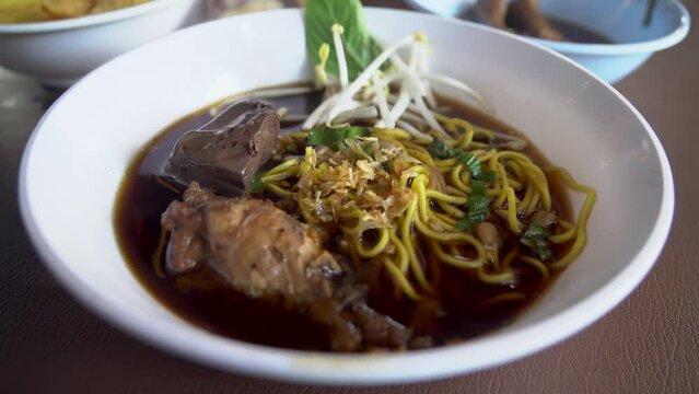 Braised chicken wings chicken feet chicken blood bitter gourd noodle.food lunch.Bitter Gourd Chicken Noodle with Herb.