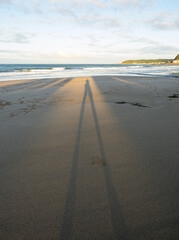 Silhoutte of man under the sunlight reflected on the beach