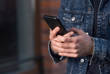 Close-up of male hands using a mobile phone or smartphone.