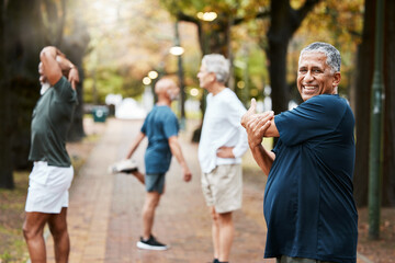 Fitness, exercise and stretching with a senior man getting ready for a workout or training outdoor at the park. Health, wellness and performance with elderly male at the start of his routine in group