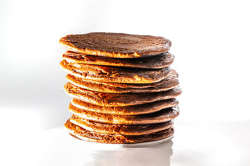Tasty chocolate pancakes on white background