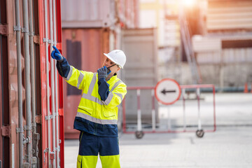 Technician working and inspecting cargo container in shipping yard,Container Shipping Logistics concept.