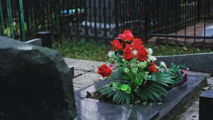 Flowers on a grave at cemetery
