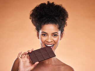 Chocolate, happy woman and beauty portrait, studio background and eating sweets, cacao dessert and...