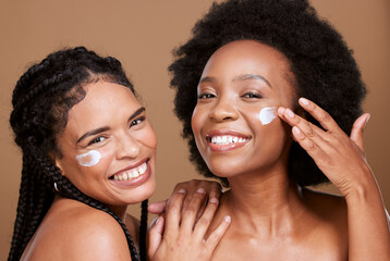 Beauty, friends and black women with face cream for skincare or moisturizing in studio on brown...