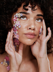 Model, makeup and beauty with flower eye for cosmetics, wellness and skin art on face in studio....