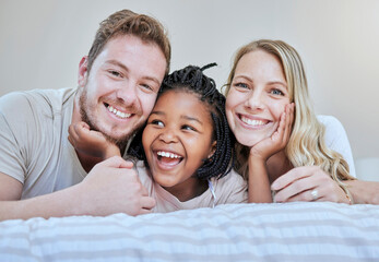 Diversity, happy family or foster parents in bedroom relax, happy or family love portrait in house or home. Mother, father and black girl with smile on bed for happiness, quality time or support