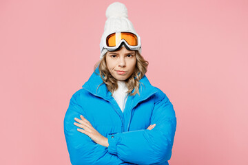 Snowboarder sad strict woman wear blue suit goggles mask hat ski padded jacket hold hands crossed folded isolated on plain pastel pink background Winter extreme sport hobby weekend trip relax concept