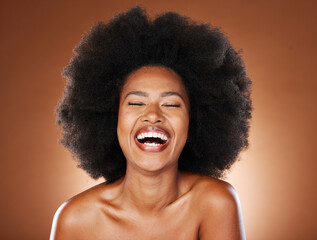 Black woman, skincare beauty and hair care model with healthy afro, natural cosmetics empowerment and happy laugh. Portrait of proud, confident and beautiful young African girl in studio background