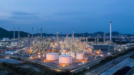 Fototapeta premium Aerial view Oil and gas industrial, Oil refinery plant form industry, Refinery factory white oil storage tank, Oil refinery plant from industry zone.