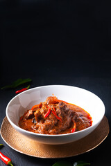 Thai cuisine concept homemade beef Red curry Panang on black background with copy space
