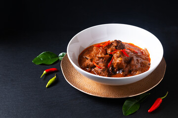 Thai cuisine concept homemade beef Red curry Panang on black background with copy space