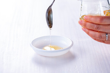 Honey dripping from spoon.
Sweet honey image.
