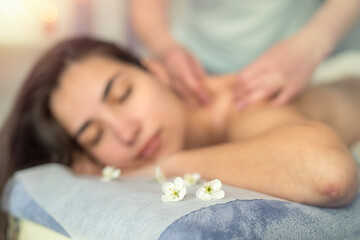 Pretty slim woman receiving a health massage treatment in a spa center - obrazy, fototapety, plakaty