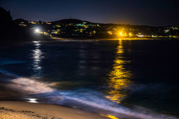 Night time at the beach under the dark of a lunar eclipse