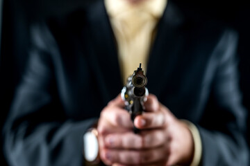 man in tuxedo and shirt without face holds  in his hands near his chest isolated background.