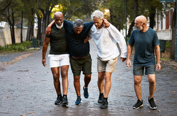 Help, injury and fitness with man friends in a park together for exercise, training or fitness. Health, workout and accident with a male athlete suffering in pain during outdoor sports with a friend