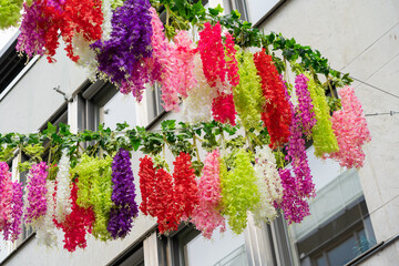 Colorful flower chains hanging between the houses
