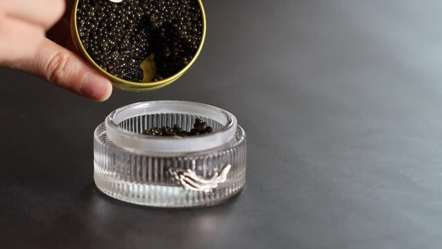 Black caviar is transferred to a bowl