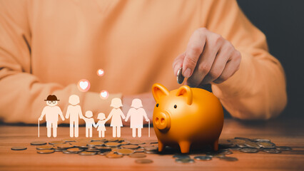 Father is head of the family, putting coins on piggy bank with family icon on the table. Concept...