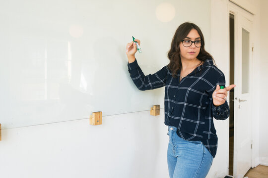 Woman giving presentation in conference room