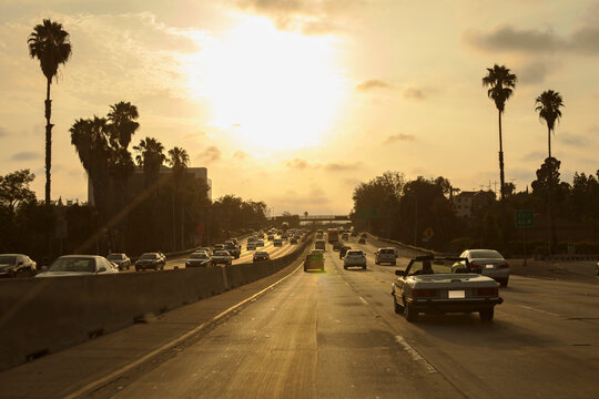 Cars driving on 101 Freeway at sunset in Los Angeles, California