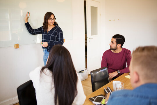 Woman giving presentation in conference room - Powered by Adobe