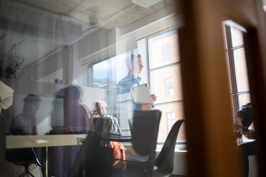 Coworkers meeting in office conference room