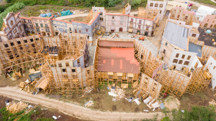 Aerial view on constructions for film sets. The buildings in the set are empty and kept with wooden...