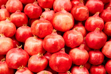 Pomegranate fruits food background. Heap of fresh pomegranates