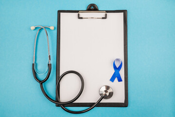  stethoscope clipboard with sheet of paper and blue silk ribbon prostate cancer awareness symbol on...