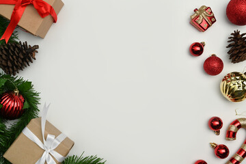 Christmas ornaments, gift boxes, pine cone and fir tree branches on white background. Top view with copy space