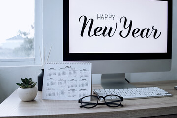 2023 calendar with Happy New Year text on computer screen on the background