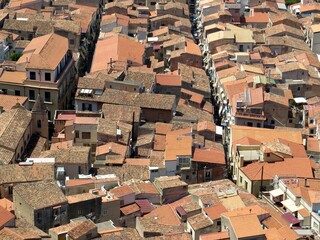 Cityscape of the red traditional house roofs of Cefalu city, Sicily, Italy