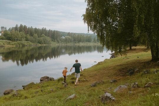 Father and daughter hiking by lake
