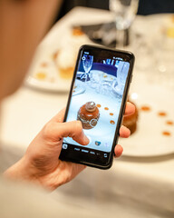 Person holding smartphone in a restaurant