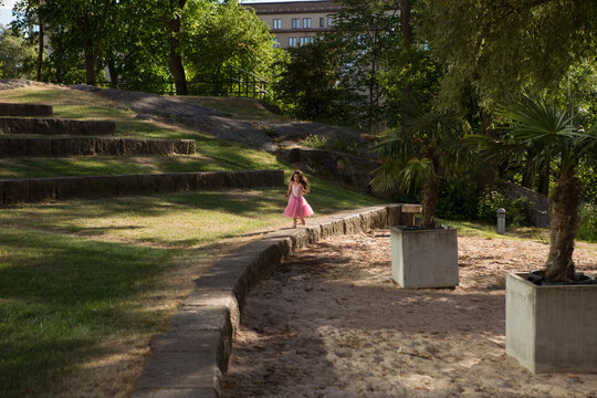 Girl in pink dress playing in park