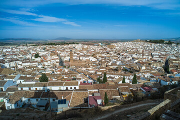 Obraz premium the city of Antequera. tight buildings, white houses, monuments, churches view from the castle hill. Peña de los Enamorados hills and rock in the background