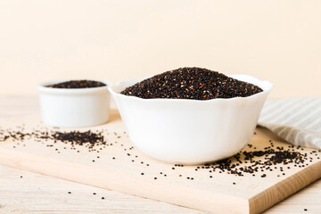 quinoa seeds in bowl on colored background. Healthy kinwa in small bowl. Healthy superfood