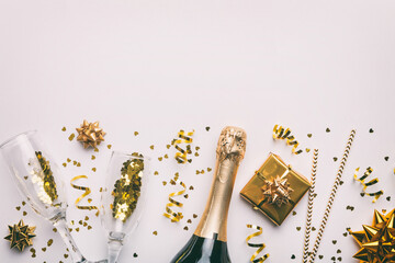Bottle of champagne with colored glitter, confetti and gift box space for text on colorfull...