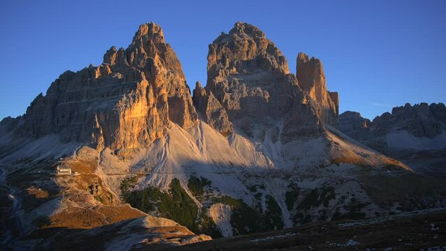 Footage filmed at Rifugio Auronzo, Tri Cine up the mountains in Italian Dolomites. Video of beautifull mountains Tri Cine, filmed at sunrise in 4k with a camera on a gimbal moving forward