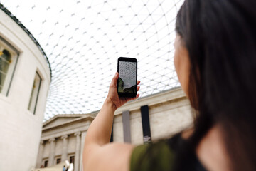 Woman tourist taking photo on cellphone