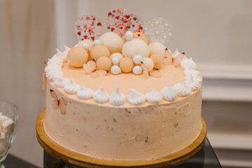 Birthday cake on a beige background. The cake is decorated with butterfly figures decor. The concept of festive desserts. Close up.